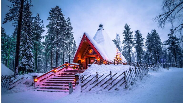 Snow-covered cabin in Santa Claus Village, Lapland.