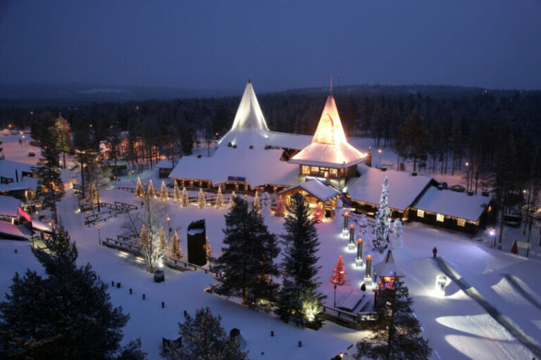 Snow-covered Santa Claus Village in Rovaniemi at night.