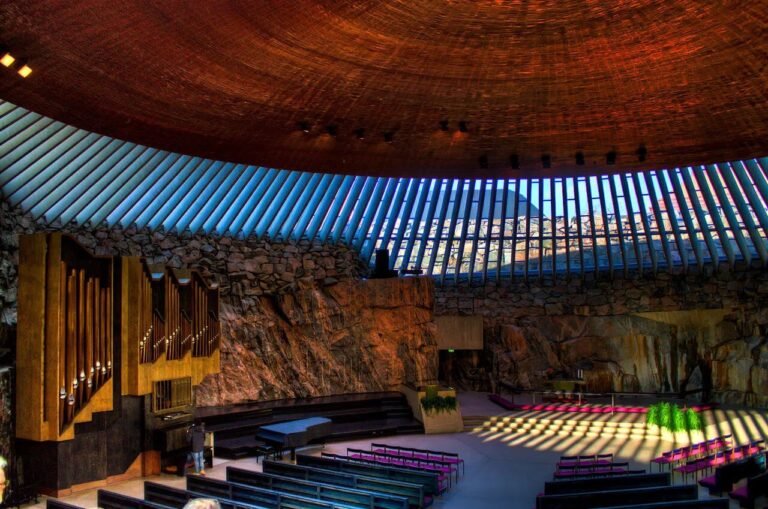 Interior of Temppeliaukio Church with stone walls and organ