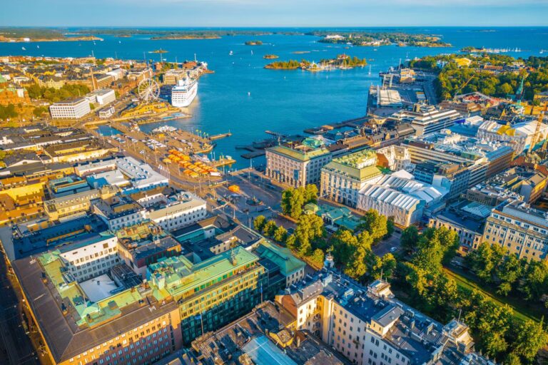 Aerial view of Helsinki harbor with ferris wheel and cruise ships.