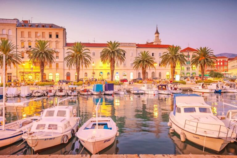 Boats docked at Split harbor in Croatia during sunset.