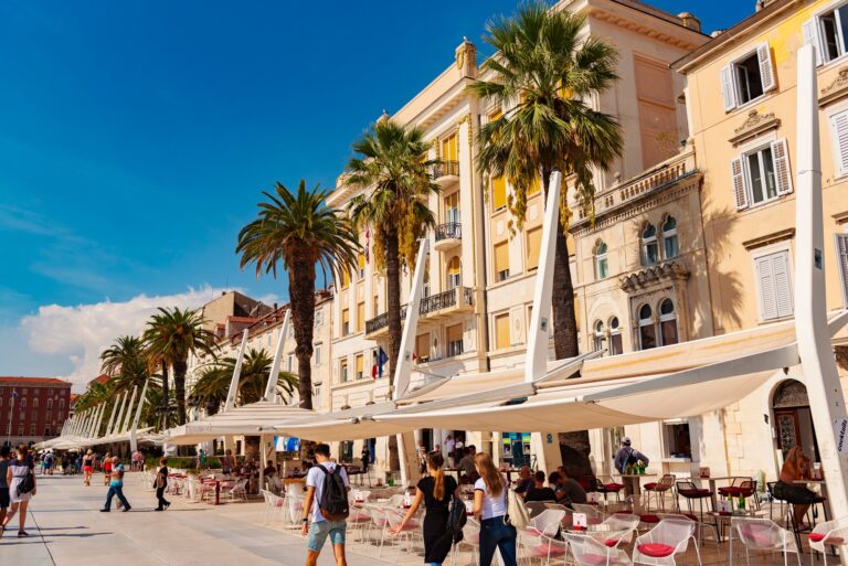Promenade in Split with palm trees and outdoor cafes