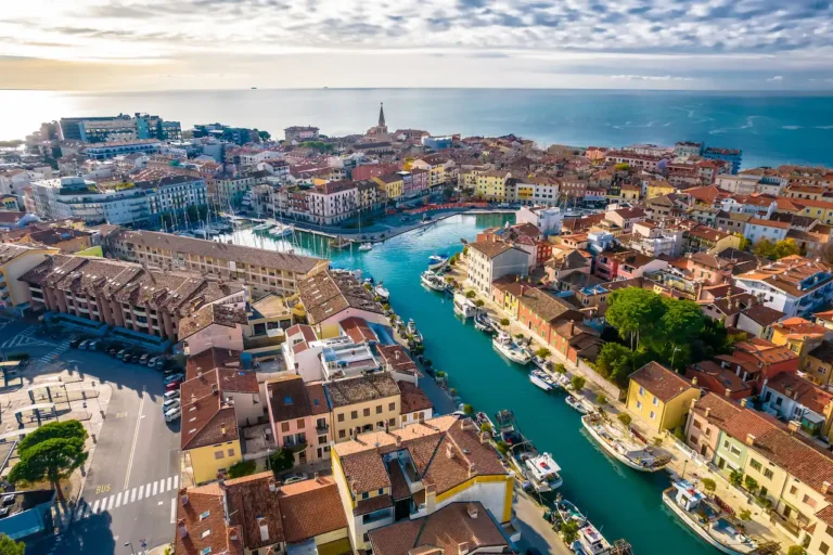 Aerial view of a picturesque canal town with colorful buildings.