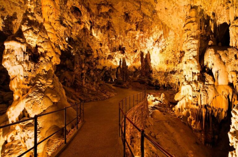 Illuminated stalactites and stalagmites in Postojna Cave, Slovenia.