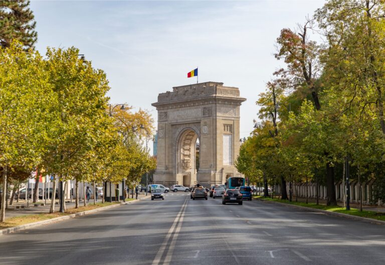 Triumphal arch in Bucharest with cars and trees