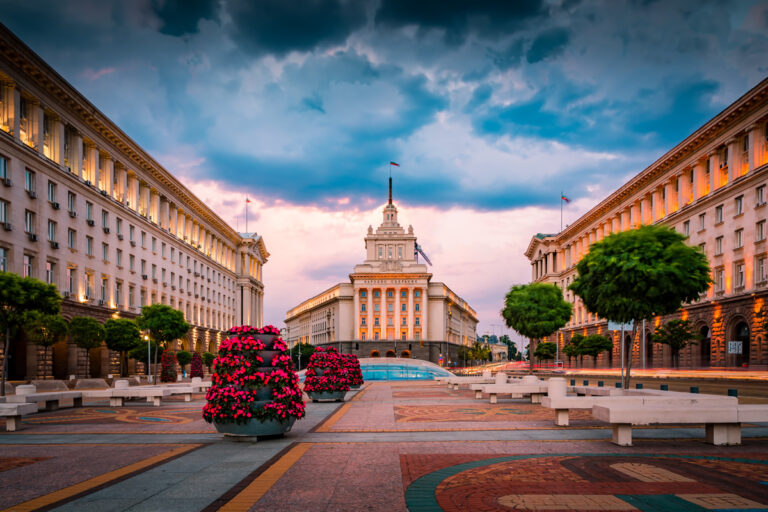 Central government buildings in Sofia with flowers and trees.