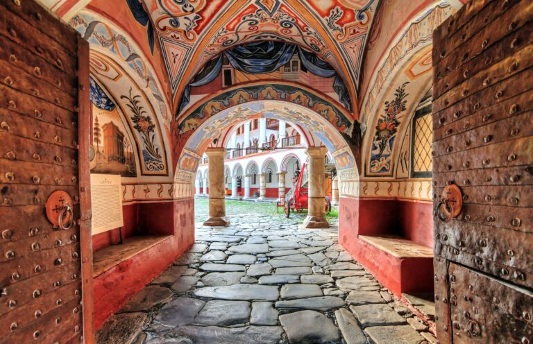 Ornate entrance with frescoes at Rila Monastery.