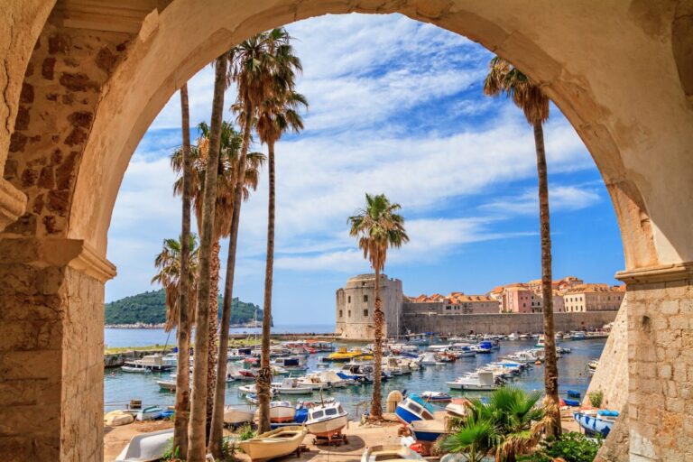 View of Dubrovnik harbor with boats and historic architecture