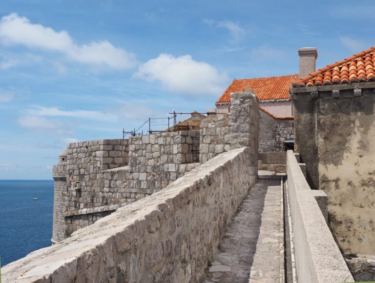 Stone walls of Dubrovnik overlooking the sea.