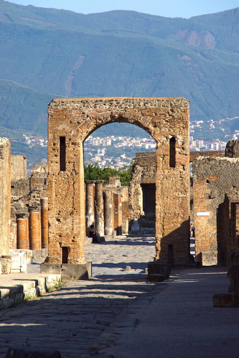 Ancient ruins of Pompeii with mountains in the background