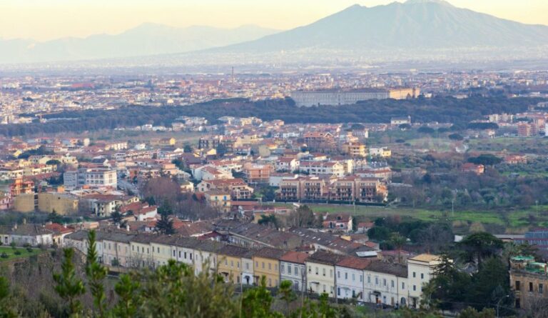 Aerial view of Caserta with Mount Vesuvius in the background.