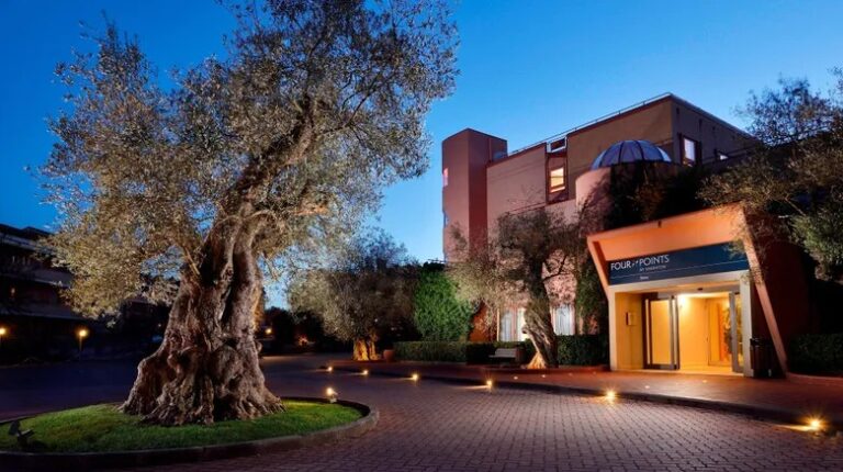 Entrance of Four Points Sheraton Hotel in Italy at dusk