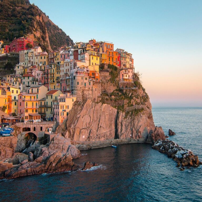 Colorful buildings on a cliffside in Cinque Terre at sunset