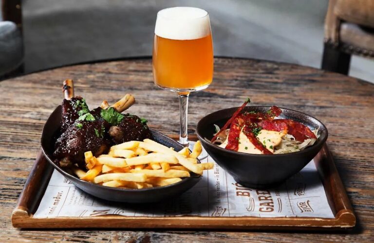 Gourmet meal with lamb shank, fries, and beer at Fosshotel Reykjavík.