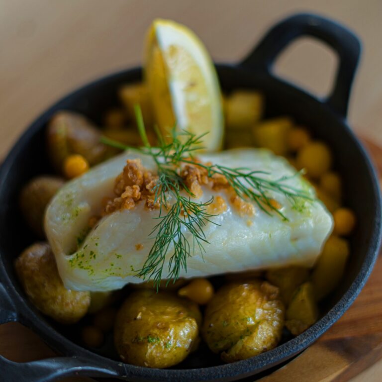 Delicious dish with fish, potatoes, and dill garnish
