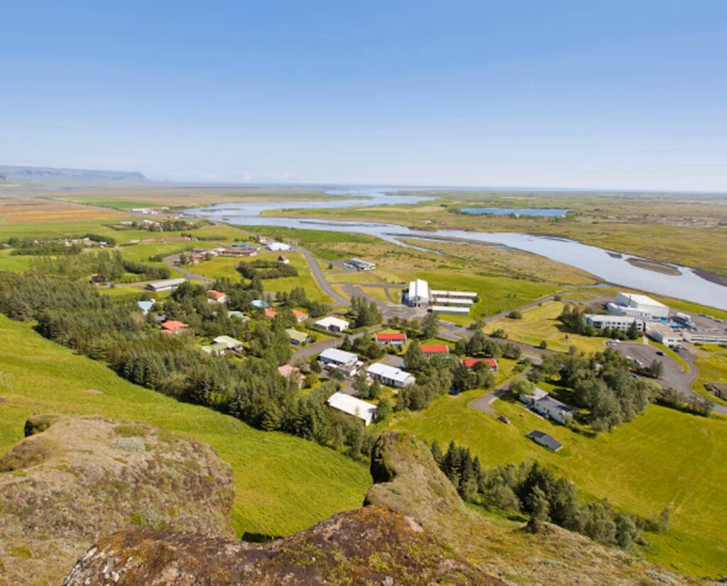 Aerial view of Klaustur Hotel in Iceland surrounded by lush greenery.