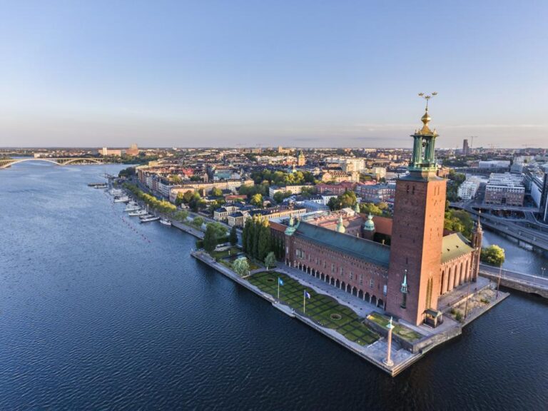 Aerial view of Stockholm City Hall by the water.