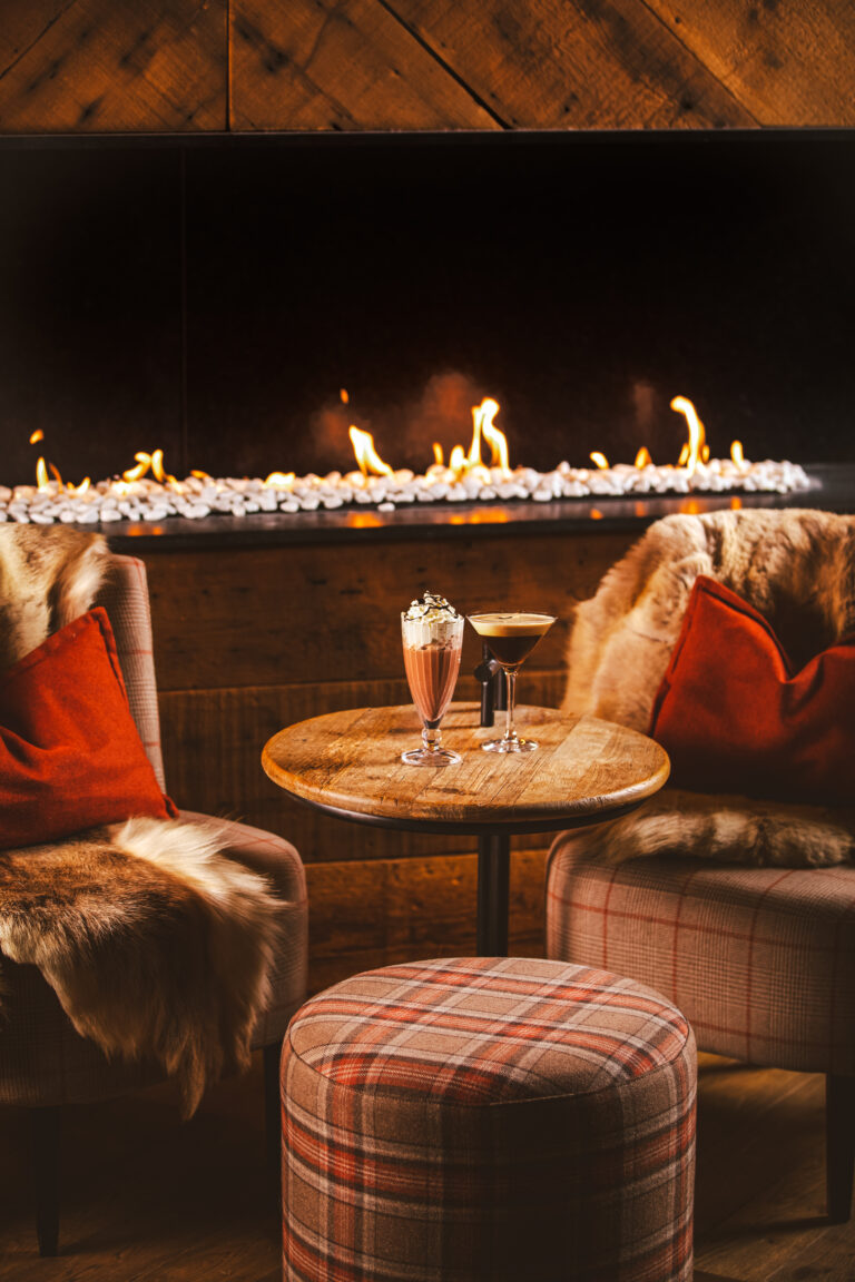 Cozy lounge with fireplace and drinks
