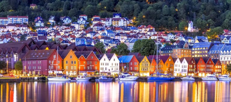 Colorful buildings along the waterfront in Bryggen, Bergen at dusk.