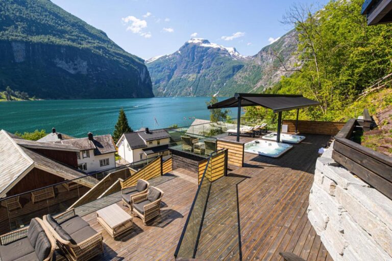 Scenic view of Geirangerfjord with outdoor terrace and jacuzzi
