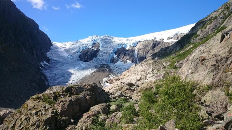 Majestic glacier in Nordic region with rocky terrain.