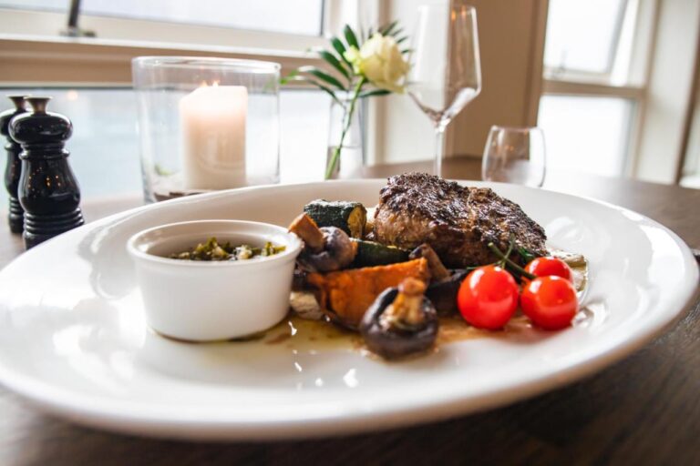 Gourmet meal with steak, vegetables, and sauce at Geiranger Hotel.