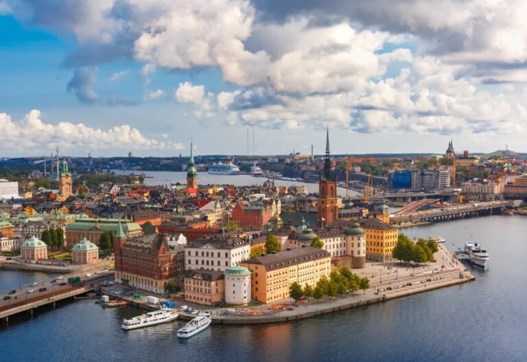 Aerial view of Stockholm cityscape with water and historic buildings.
