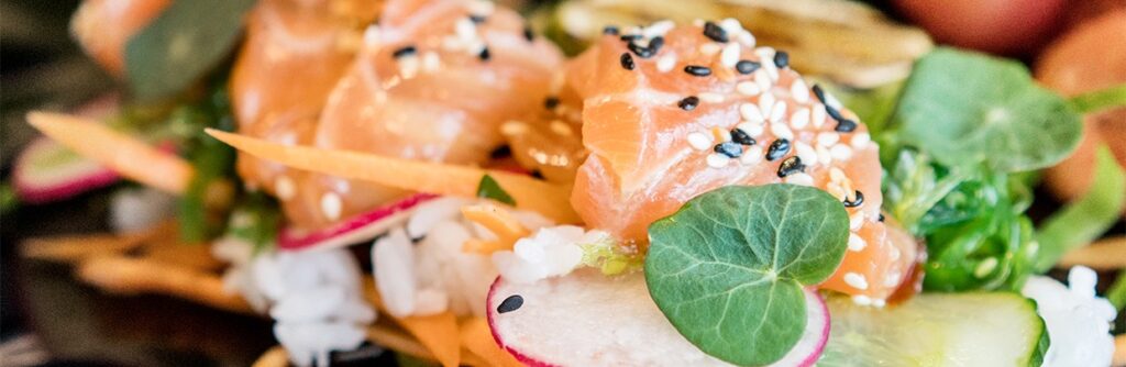 Fresh salmon dish with sesame seeds and greens