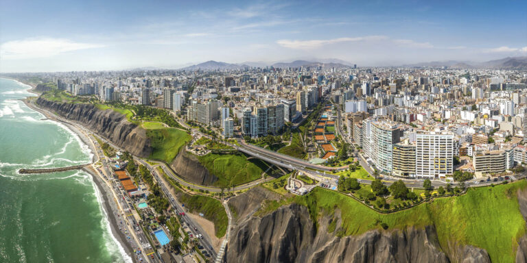 Aerial view of Lima's coastline and cityscape.