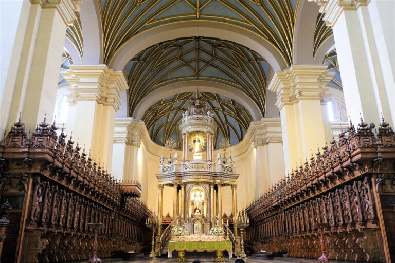 Ornate cathedral interior with altar and wooden choir stalls