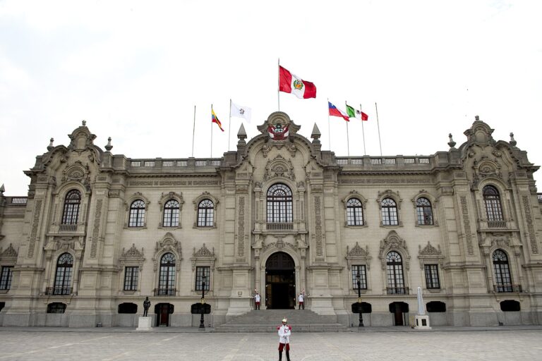Presidential Palace in Lima with flags and guards.