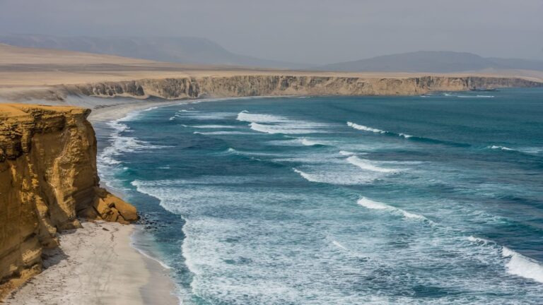 Coastal cliffs of Paracas National Reserve with ocean waves.