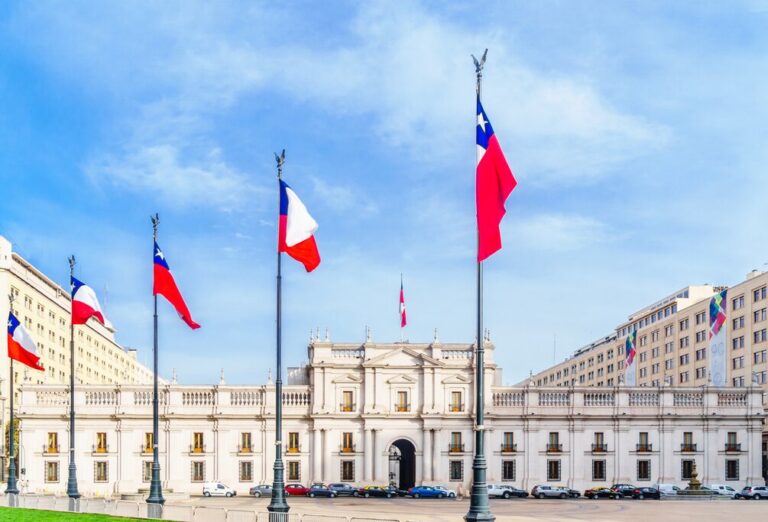 La Moneda Palace with Chilean flags in Santiago