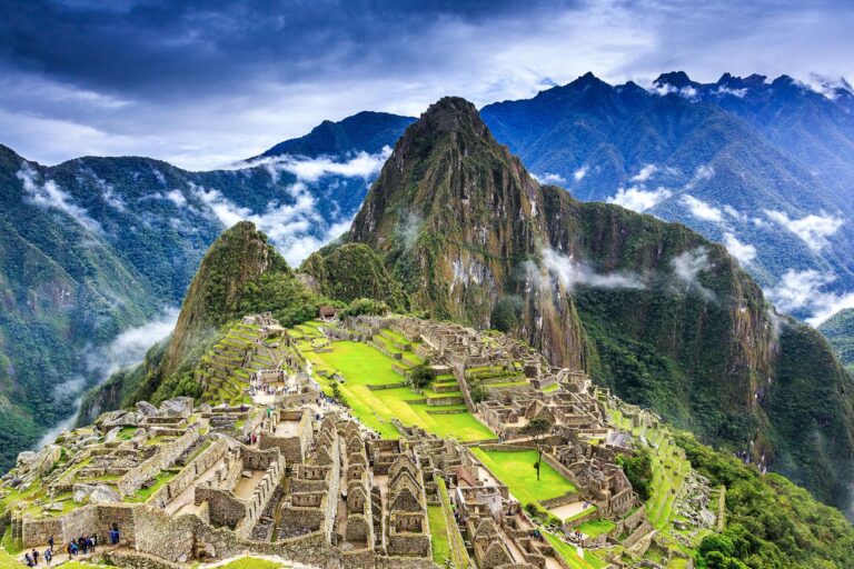 Machu Picchu ancient ruins with mountains and clouds