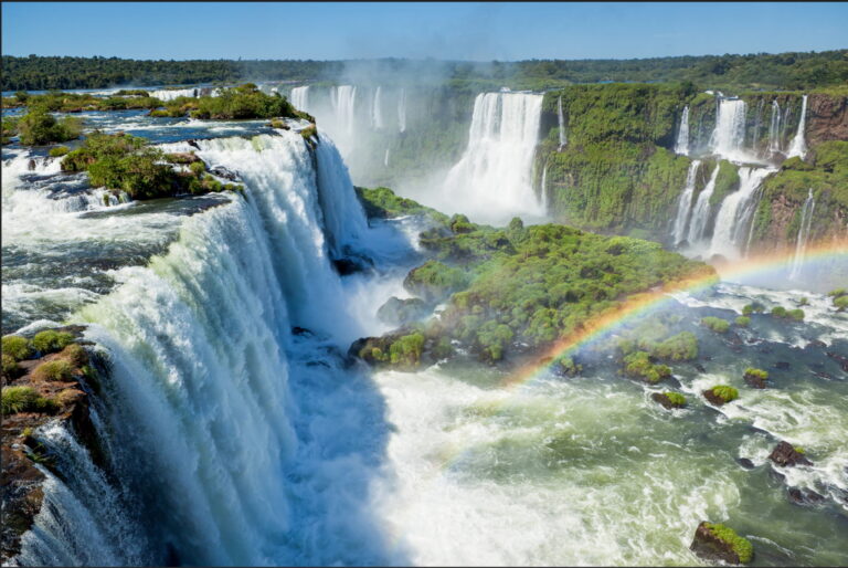 Majestic view of Iguazu Falls with a rainbow