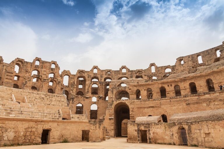 Ancient El Jem amphitheater ruins under a blue sky